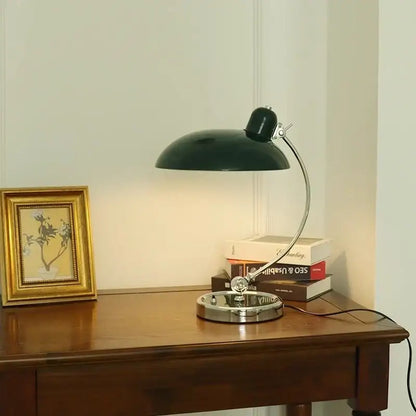 Dark green metal vintage desk lamp with curved chrome arm and circular base for bauhaus vintage desk lighting
