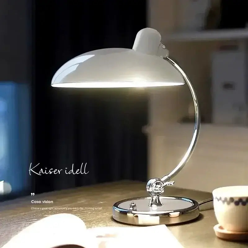 A sleek bauhaus vintage desk lamp with a glossy white dome shade and polished chrome base for office or bedroom use