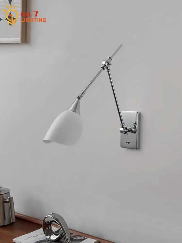 A bauhaus vintage swing arm wall lamp with chrome articulated arm and matte white conical shade for modern living rooms
