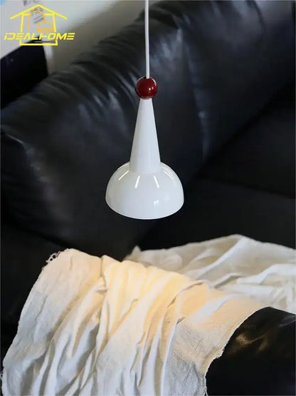 A sleek white conical bauhaus colorful led pendant light with a glossy finish and a small red spherical accent