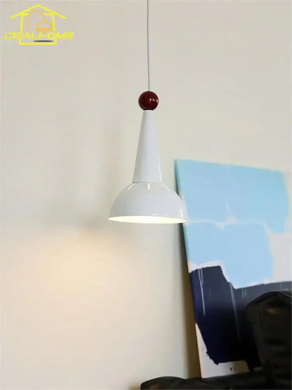 A sleek bauhaus colorful led pendant light with a white conical shade and glossy red spherical top for kitchen use