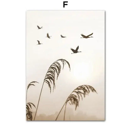 Silhouetted birds in flight above tall reeds on a soft beige canvas wall art for bohemia beach home decor by decorbites