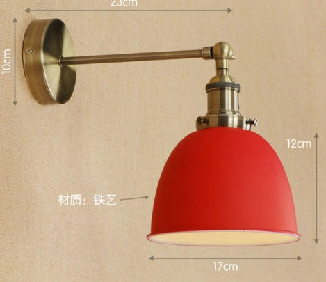 Red dome-shaped iron bedroom wall lamp with brass accents and adjustable arm for versatile lighting
