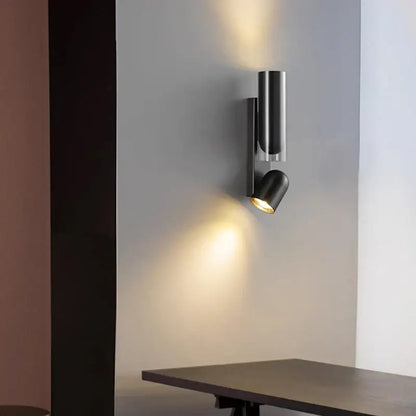 Modern black cylindrical wall sconce with minimalist design for adjustable bedroom wall reading lamps and wall reading use