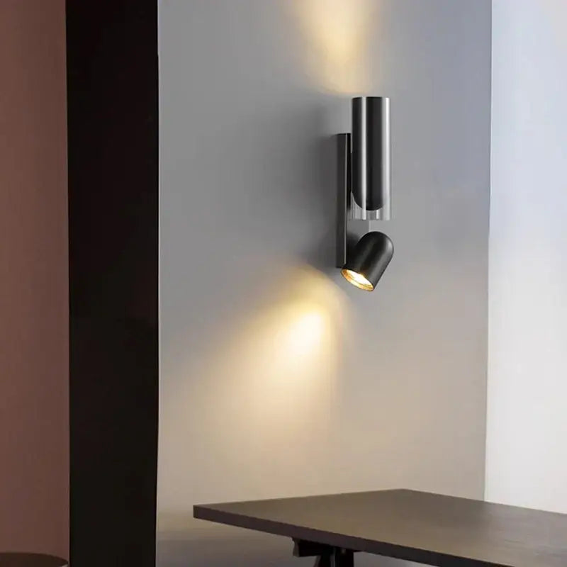 Modern black cylindrical wall sconce with minimalist design for adjustable bedroom wall reading lamps and wall reading use