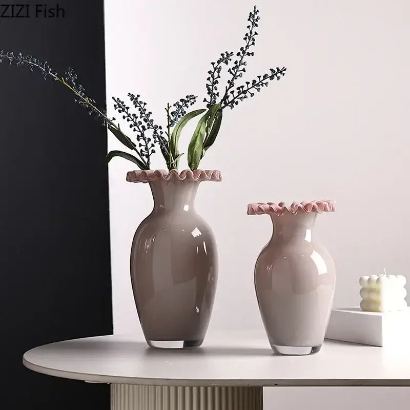 Two elegant matte gray ceramic vases with pink flower edge rims holding dark purple floral stems for living room use