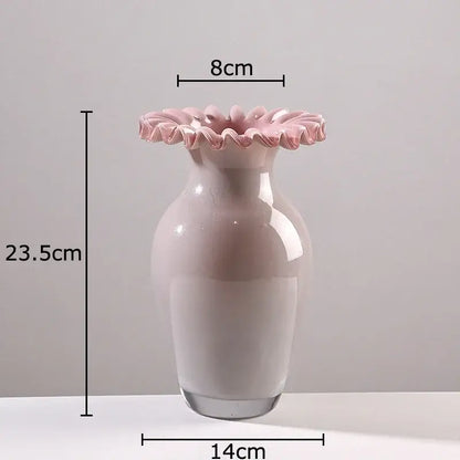 A delicate blush pink glass vase with a pink flower edge rim and smooth rounded body for living room decor