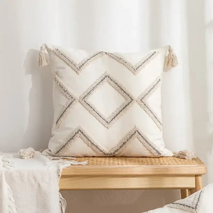 Beige and white cushion cover with decorbites geometric embroidery tassel design featuring black and beige woven lines