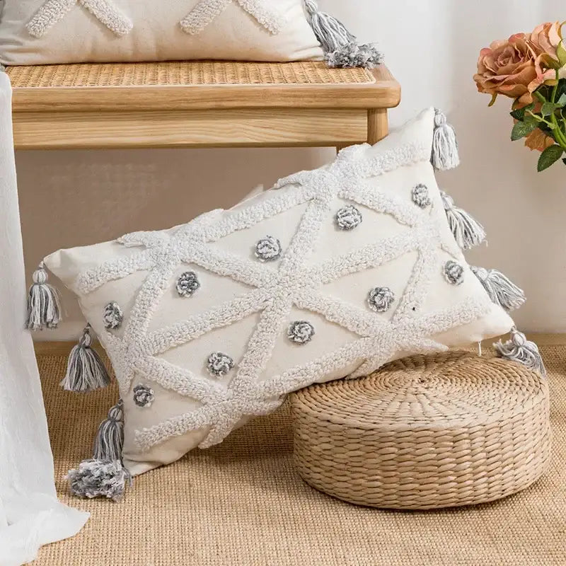 Cream-colored cushion cover with beige and white geometric embroidery tassel and gray floral accents for living room decorbites