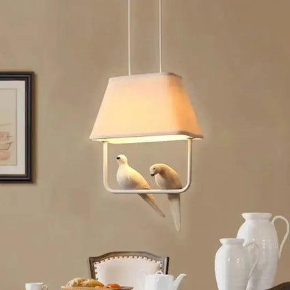 Beige bird cloth chandelier with white fabric shade and sculpted doves in minimalist metal frame for dining room decorbites bird cloth