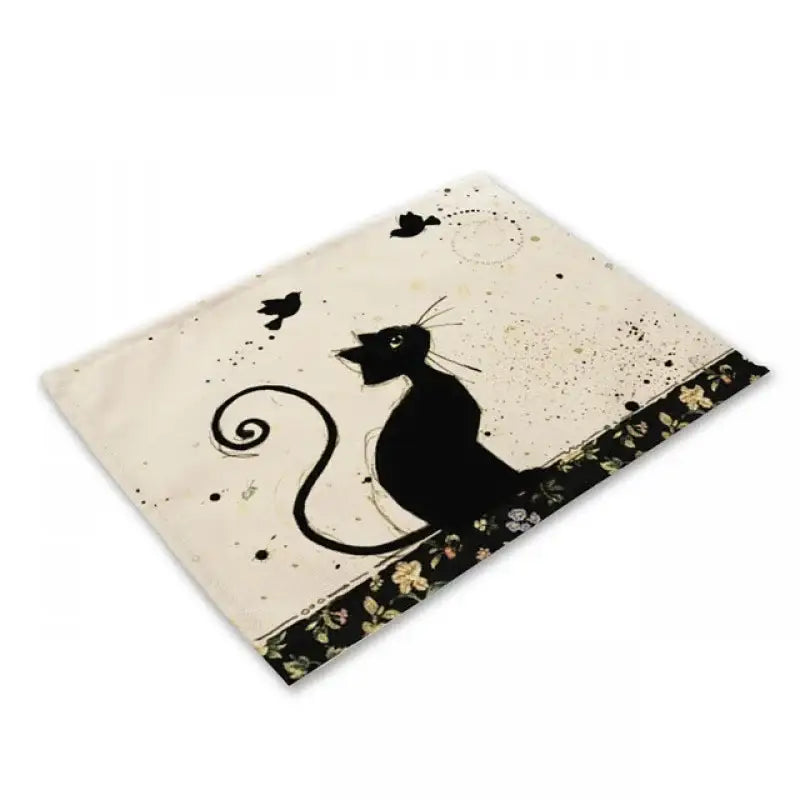 Beige and black cat linen placemat featuring a cream rectangular mat with a black cat silhouette and floral border decorbites black cat