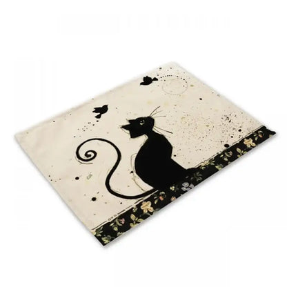 Beige and black cat linen placemat featuring a cream rectangular mat with a black cat silhouette and floral border decorbites black cat