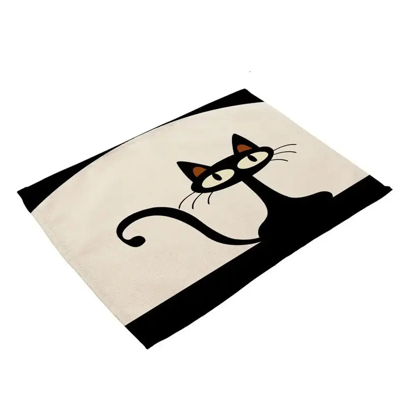 Cream-colored cotton cat linen placemat featuring a stylized black cat with orange ears and bold black stripes decorbites black cat