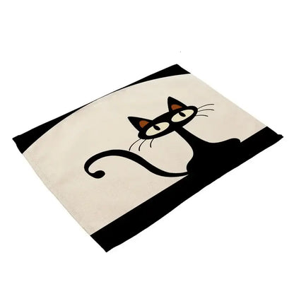 Cream-colored cotton cat linen placemat featuring a stylized black cat with orange ears and bold black stripes decorbites black cat