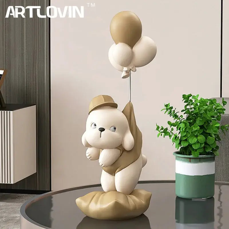 Beige ceramic balloon puppy statue figurine of a cute puppy wearing a hat and holding balloons for living room decor