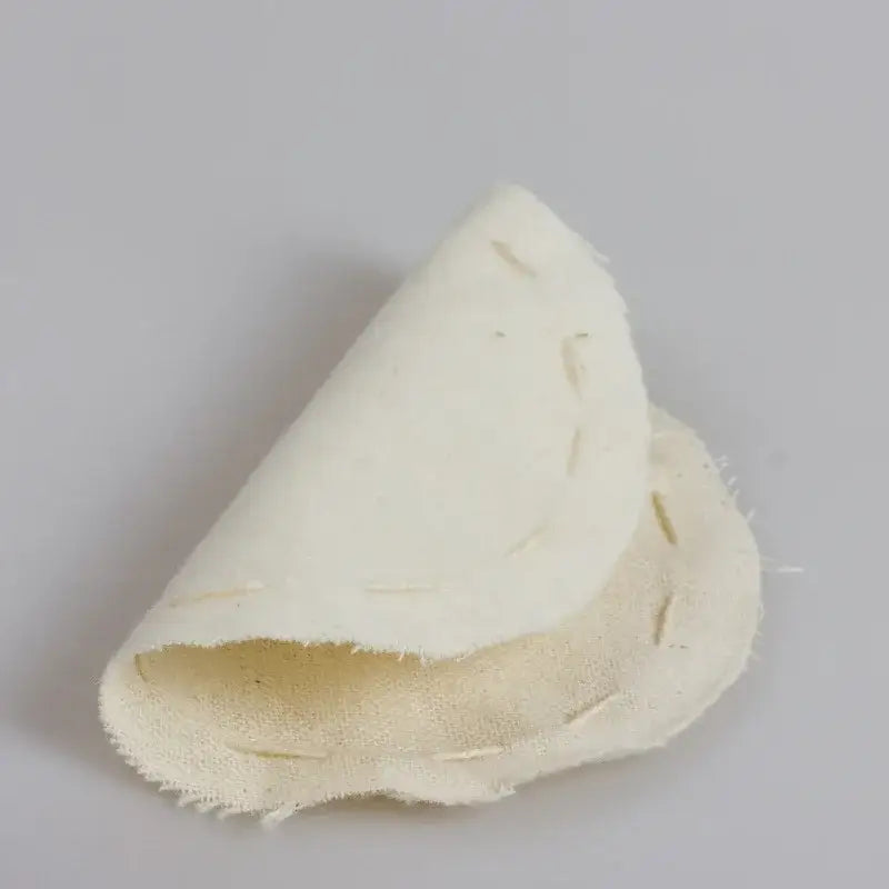 A beige eco-friendly flannel cloth coffee filter pouch with a soft textured surface and visible stitching edges