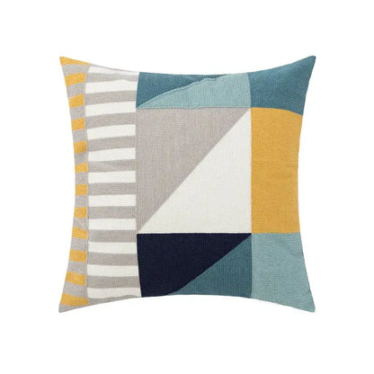Beige embroidered daisy floral pillow cover with geometric patchwork design in muted blues mustard yellow and navy accents