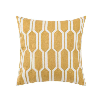 Square throw pillow cover with mustard yellow base and white geometric patterns, featuring embroidered daisy floral design