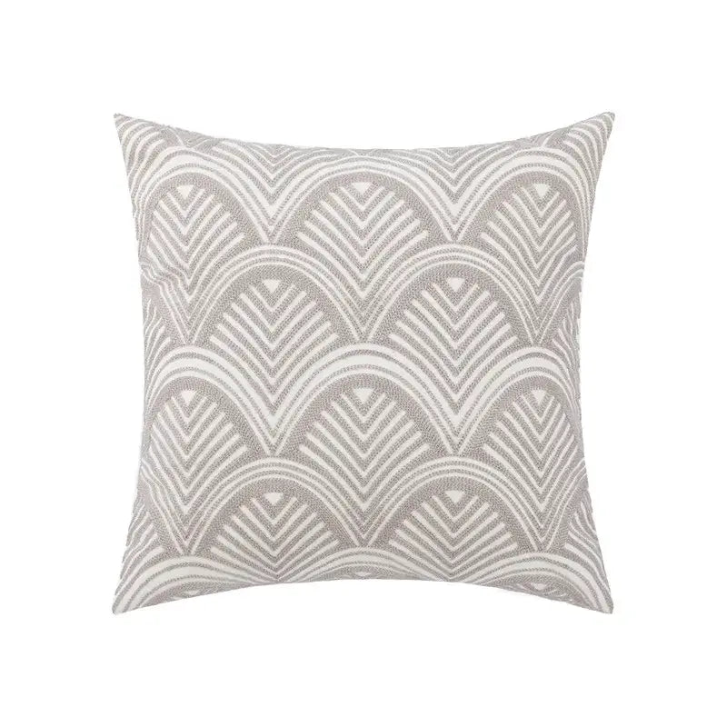A square pillow cover with a textured gray and white wave pattern complementing embroidered daisy floral decor