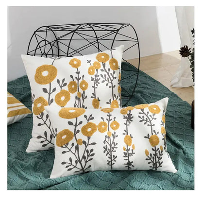 Beige pillow cover with embroidered daisy floral design in yellow and gray for elegant bedroom decor