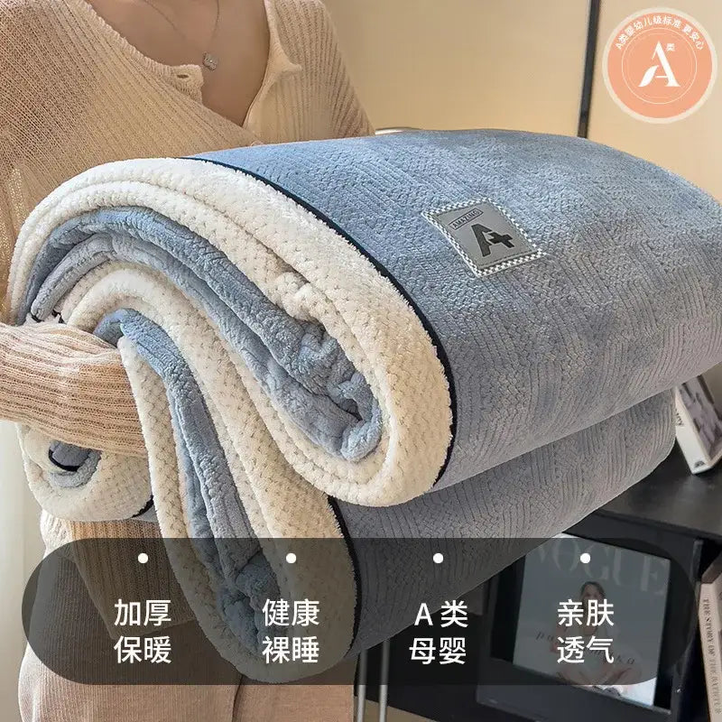 Beige and gray luxury velvet plush cotton blanket with a soft fleece texture and branded patch for bedroom use
