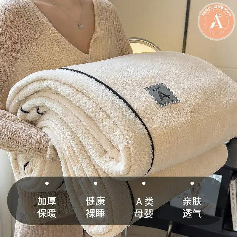 Beige and gray luxury velvet plush cotton blanket with cream-colored soft textured surface and black trim edges