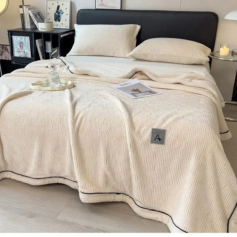 Beige and gray luxury velvet plush cotton bedroom throw with cream textured knit, black piping, and gray patch pocket
