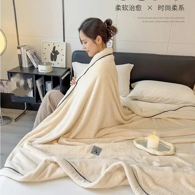 Cream-colored luxury velvet plush cotton blanket with soft textured surface and black trim for bedroom throw use