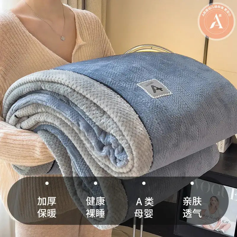 A plush double-sided blue and gray fleece blanket with luxury velvet plush cotton texture for bedroom throw use