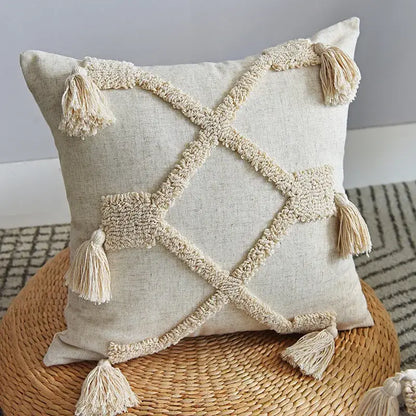 Beige linen pillowcase set with cream-colored woven tassels forming a cross pattern decorbites handmade geometric tufted design