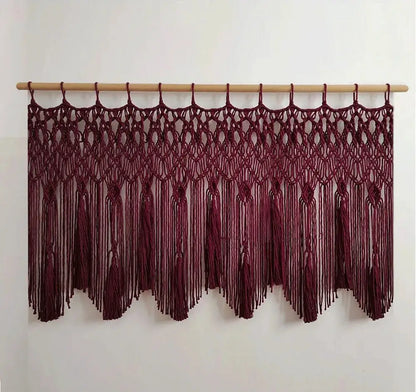 Maroon decorbites handwoven macrame wall hanging with intricate knotwork and tassels on a light wood rod for living room decor
