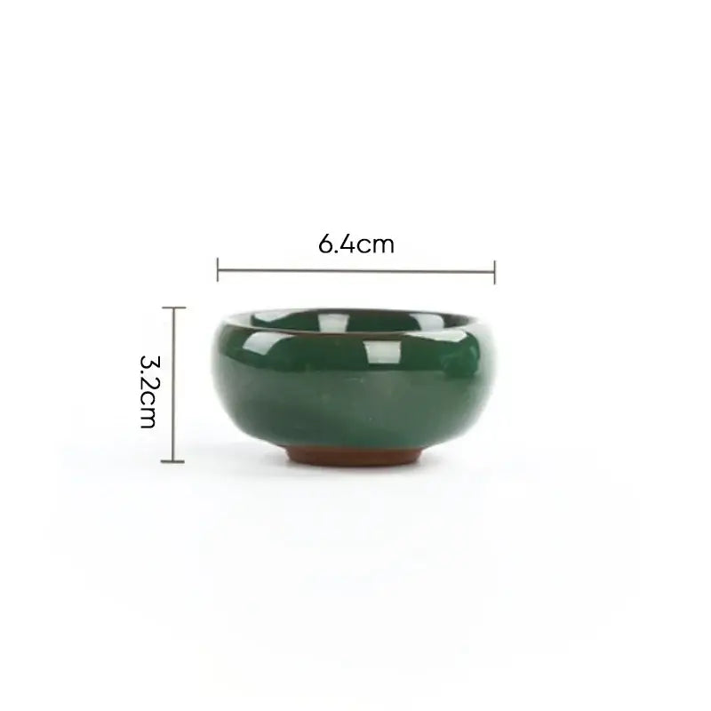 A small dark green glossy ceramic bowl with a rounded shape in decorbites ice cracking ceramic tea set