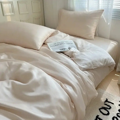 Cream-colored satin duvet cover set with matching pillowcases softly draped featuring ice silky solid decorbites bedding set