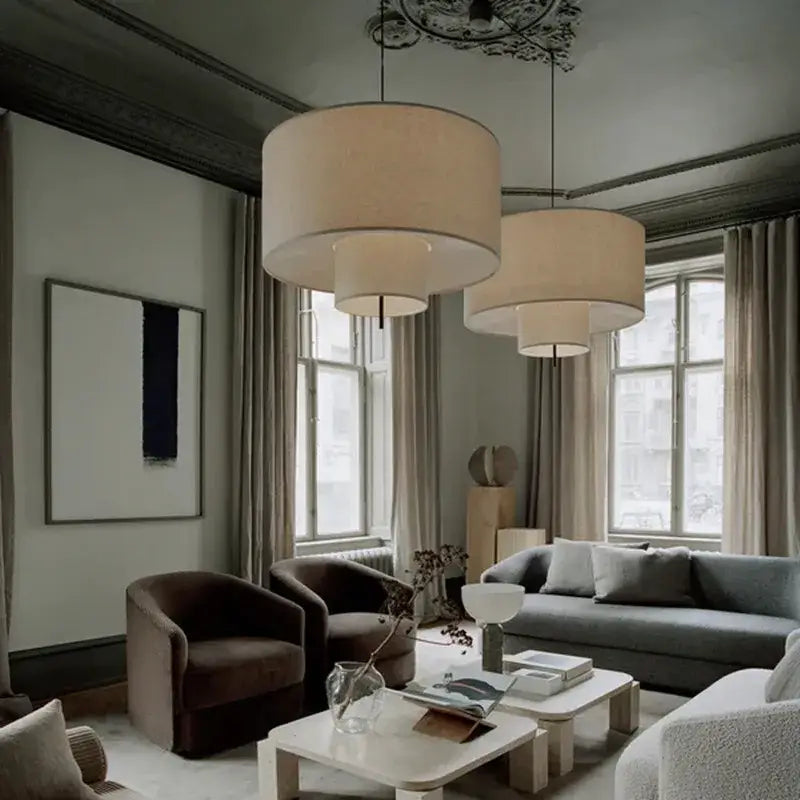 Beige linen bohemia fabric pendel lamp with soft diffused light hanging from ornate ceiling fixture for office or living room
