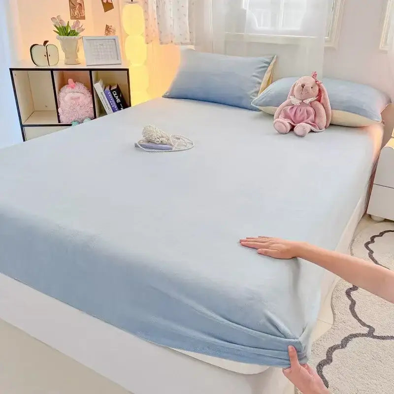 Light blue velvet fitted sheet with elasticized edges and soft texture for bedroom plush mattress topper use