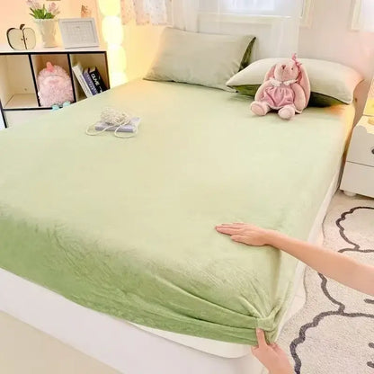 Soft mint green fitted sheet with subtle textured weave made of beige milk velvet fitted sheet material for bedroom use