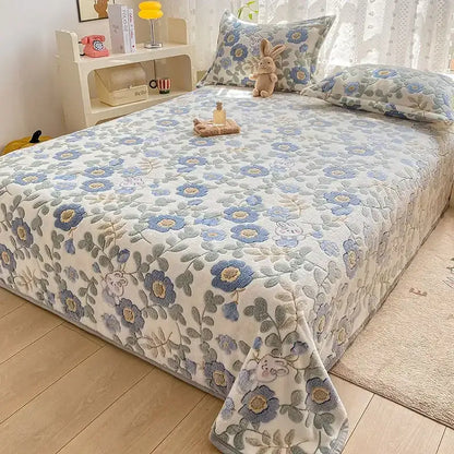 A cozy cartoon flannel blanket with soft blue and gray embroidered floral pattern used as a sofa cover from decorbites cartoon flannel