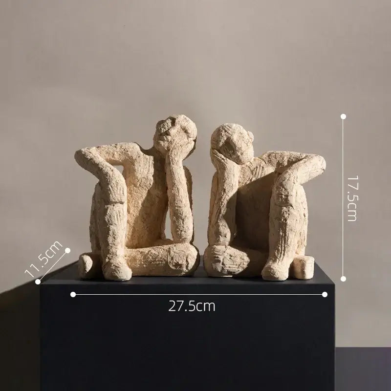 Beige textured abstract resin figurine sculpture depicting two seated human figures for living room decorbites decor