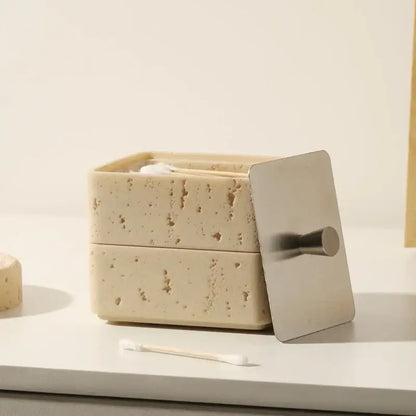 Beige textured natural stone double decker jewelry organizer with a sleek silver metal lid and handle for bathroom use
