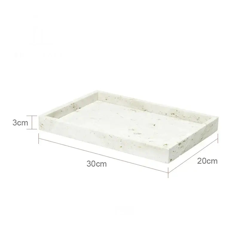 A rectangular white stone tray with speckled texture and raised edges in decorbites beige travertine marble bathroom set