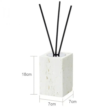 Beige travertine marble reed diffuser with white textured stone base and four black reeds from decorbites bathroom set