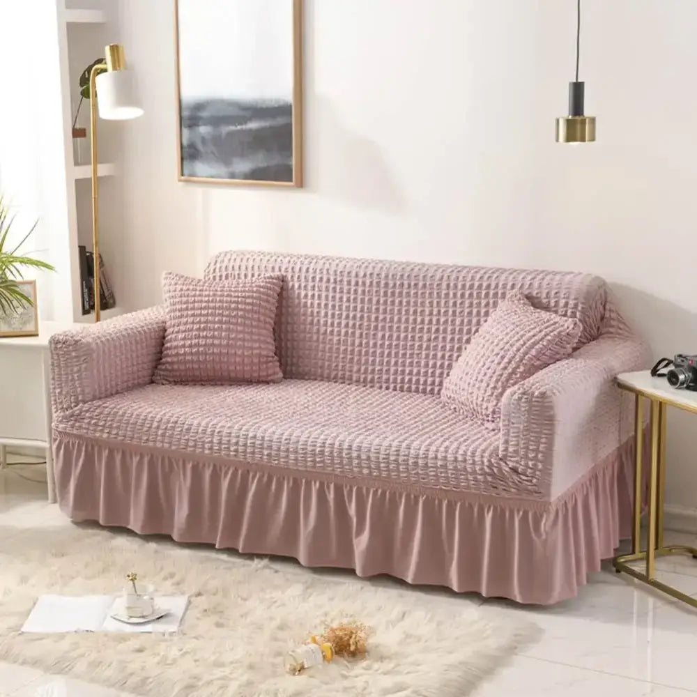 Pink waffle-textured stretch sofa cover with ruffled hem solid color cozy sofa cover for living room use