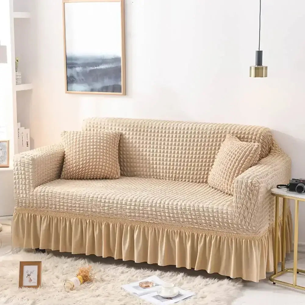 Beige waffle cozy sofa cover with textured fabric ruffled hem and matching pillow covers solid color slipcover