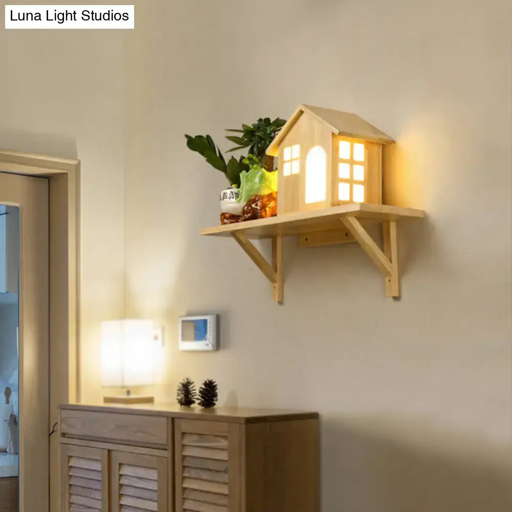 Beige wooden house wall sconce with storage shelf and warm white light featuring cut-out windows and a small plant