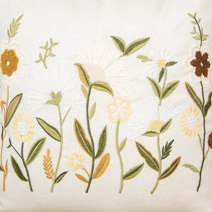 Delicate bird embroidered cotton cushion cover with white yellow brown flowers and green leaves on off-white fabric