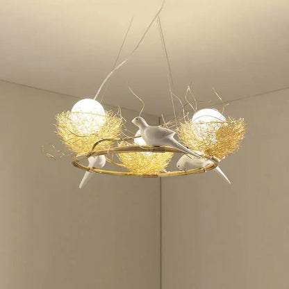 Delicate gold-toned bird nest led pendant light with white ceramic birds and spherical bulbs for dining room decor