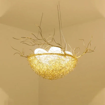 Golden wire nest led pendant light with delicate branch extensions and glowing white bulbs for dining room decor