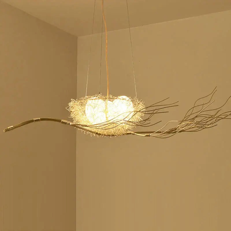 A warm-toned rustic bird nest led pendant light crafted from woven twigs and wire for dining room and cafe decor