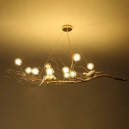 Warm-toned metal bird nest led pendant light resembling a branch with birds featuring spherical bulbs for dining room decor