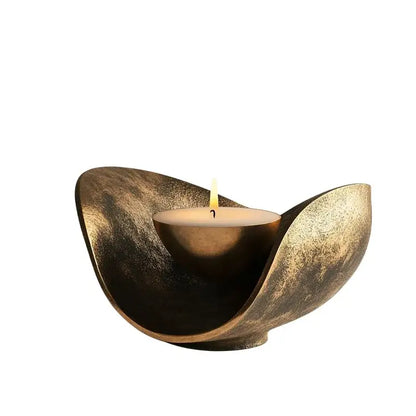 Antique brass leaf-shaped candlestick holder with a lit tea light for dining room decorbites golden banana decor